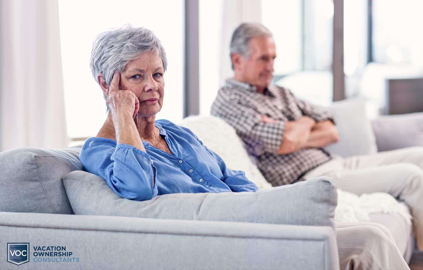 elderly husband and wife on couch sulking because of poor vacation ownership decision to cancel contract