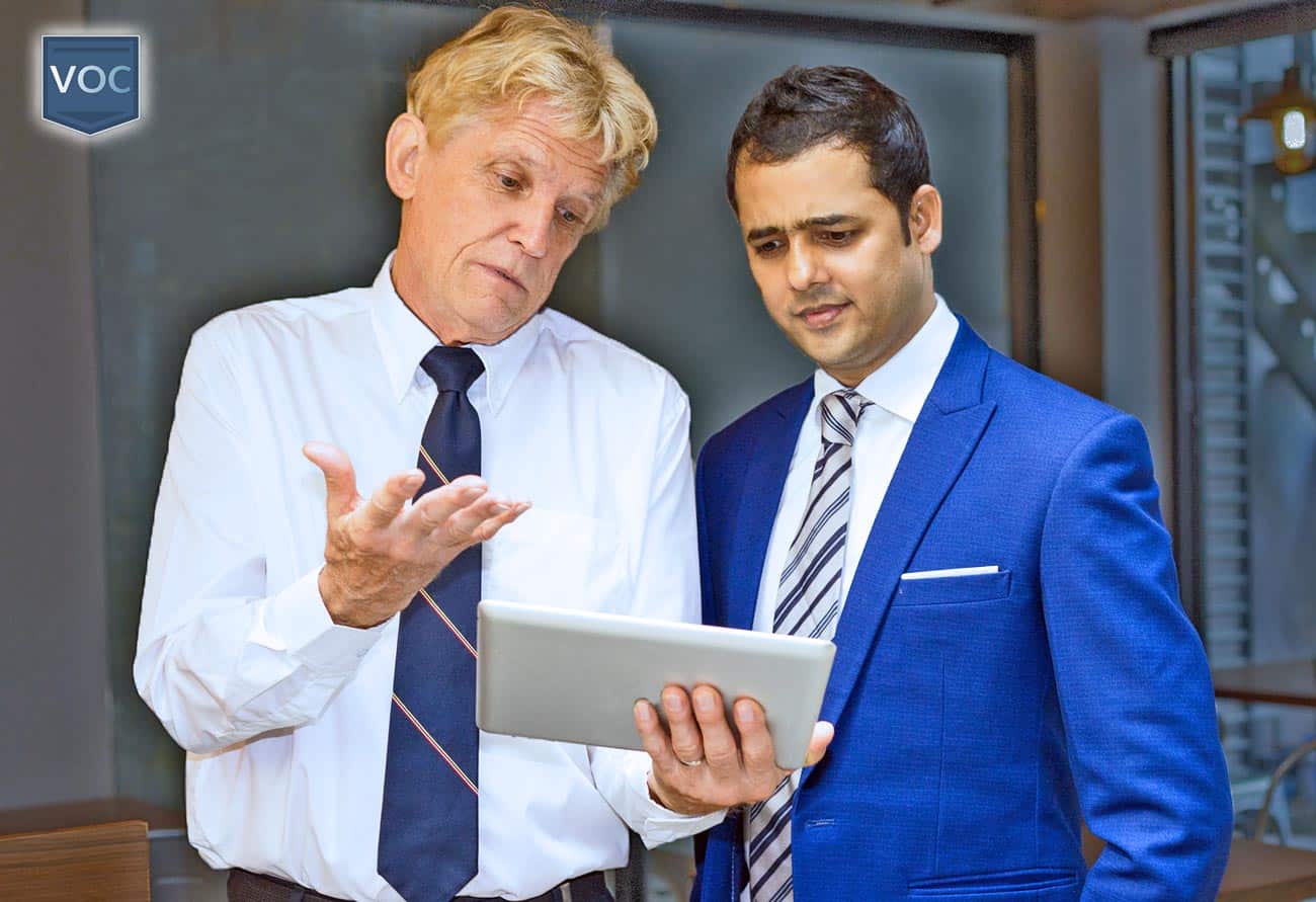 man-looking-at-tablet-business-plan-with-other-in-blue-suit-trying-to-figure-out-how-to-get-rid-of-timeshare-purchases