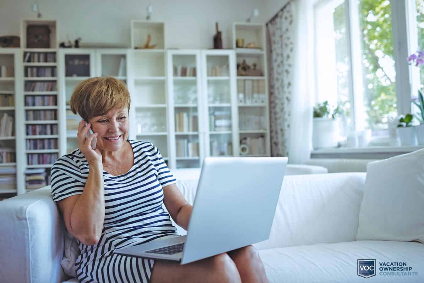 older-woman-making-sound-decision-regarding-timeshare-exchange-company-and-enjoying-her-purchase-while-on-the-computer-on-the-couch