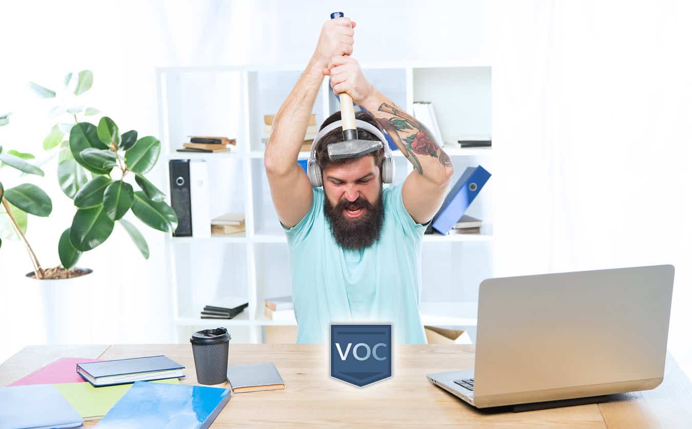 preppy-salesman-hipster-with-headphones-at-desk-smashing-voc-logo-with-hammer-instead-of-exit-timeshare-contracts