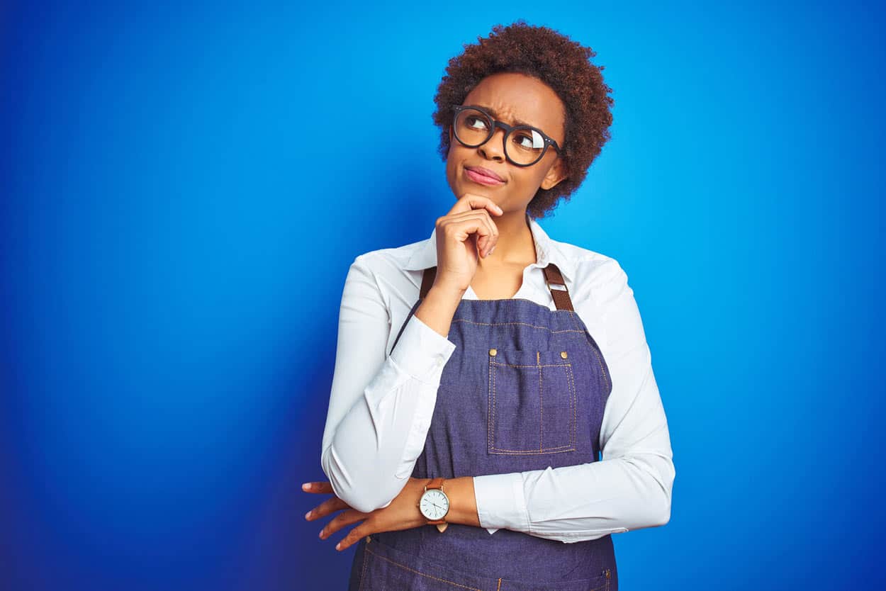 thinking-african-american-afro-young-woman-smart-insightful-and-determined-to-qualify-all-information-while-wearing-overalls