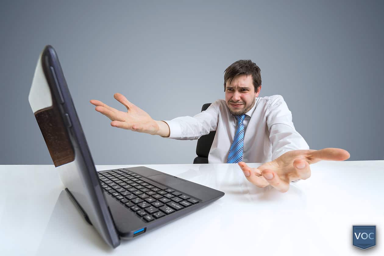funny-man-emotional-face-arms-raised-frustrated-at-laptop-computer-about-false-advertising-in-timeshare-exit-industry