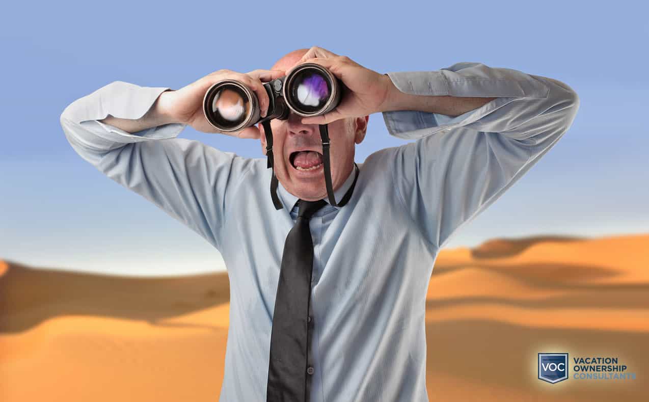 older-man-in-shirt-and-tie-looking-through-binoculars-in-desert-for-mirage-like-paid-endoresers-false-ads
