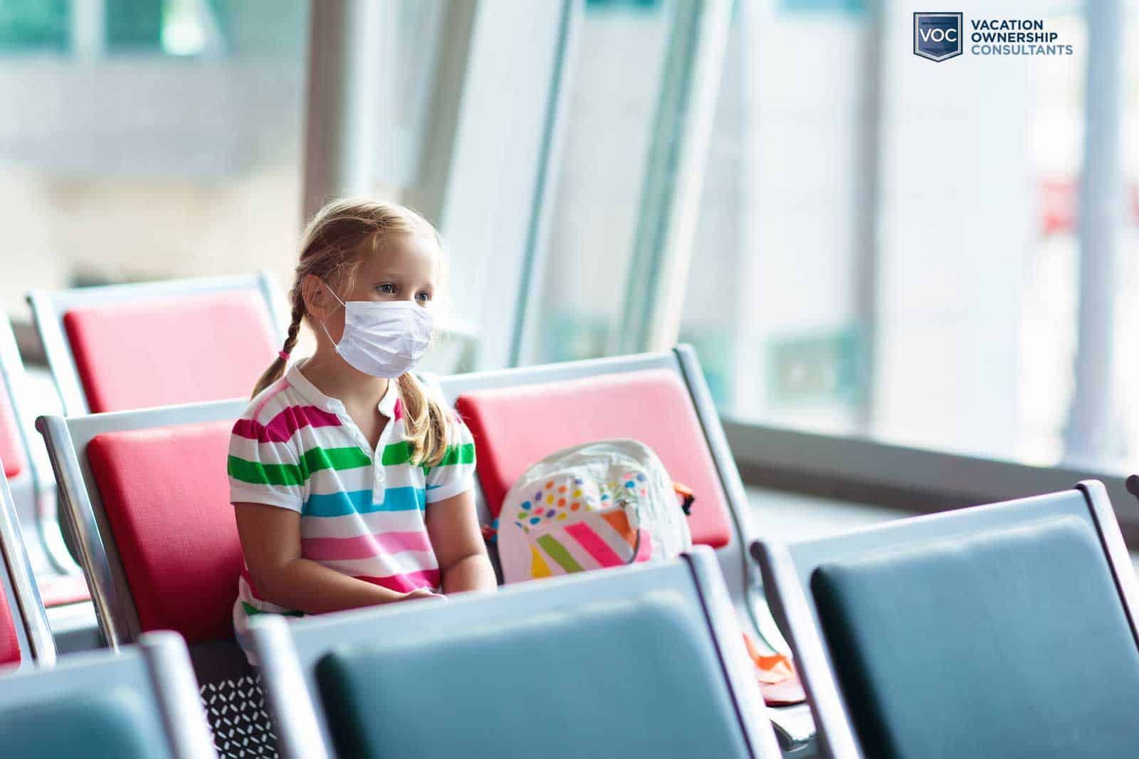 young-child-with-mask-on-face-showing-social-distancing-at-airport-to-protect-self-from-pandemic-on-vacation