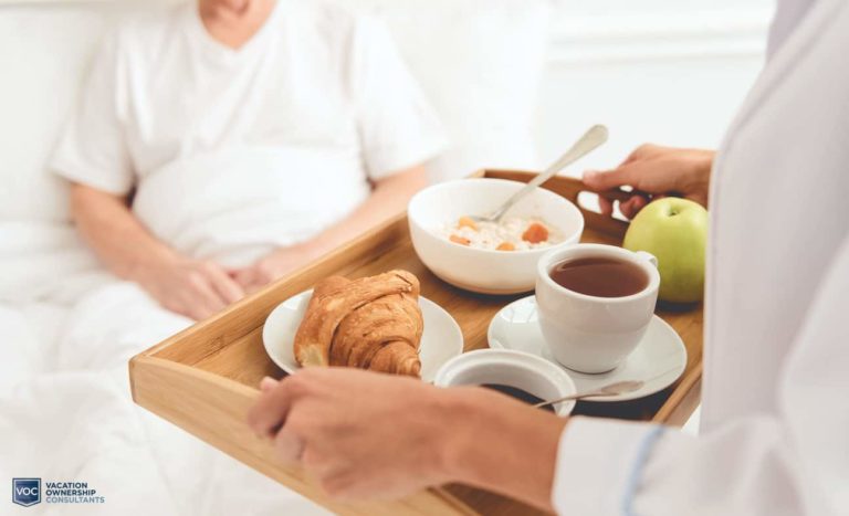 nurse-bringing-senior-citizen-resident-healthy-breakfast-in-bed-at-care-facility-like-many-vacation-owners-end-up-in