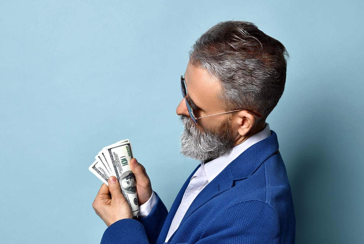 blue-suited-man-with-beard-in-shades-counting-money-as-if-he-was-accomplished-for-a-scam