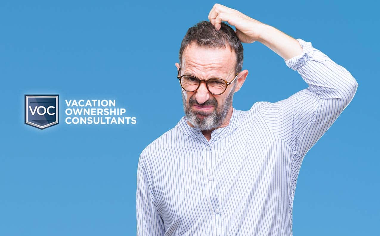vacation-ownership-consultants-white-logo-blue-background-with-middle-aged-man-in-glasses-scratching-head-as-if-confused-by-timeshare-sales-presentation-2020