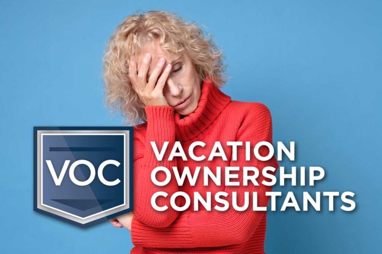 older-blonde-woman-in-bright-red-sweater-placing-palm-on-forehead-bothered-by-something-with-blue-background-signifying-worn-down-timeshare-prospect