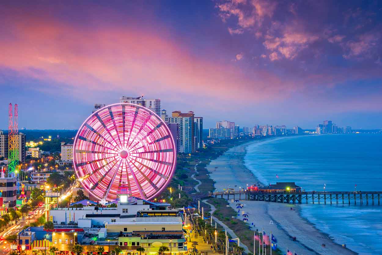 south-carolinan-shoreline-beaches-where-strip-holds-bars-and-restaurants-for-tourists-across-america-looking-to-visit-the-popular-travel-destination-beautiful-pink-orange-purple-blue-oceanfront-sunset