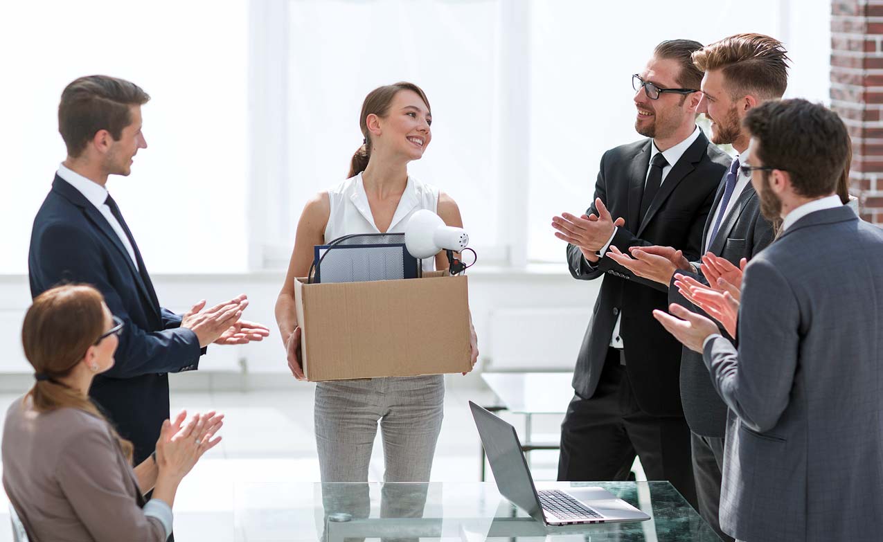 cheerful-new-employee-checking-out-new-office-space-while-male-managers-make-cheesy-remarks