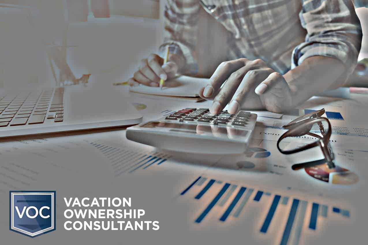 typing-in-numbers-on-calculator-to-determine-cost-of-vacation-ownership-from-vacation-owner's-perspective-by-voc-client