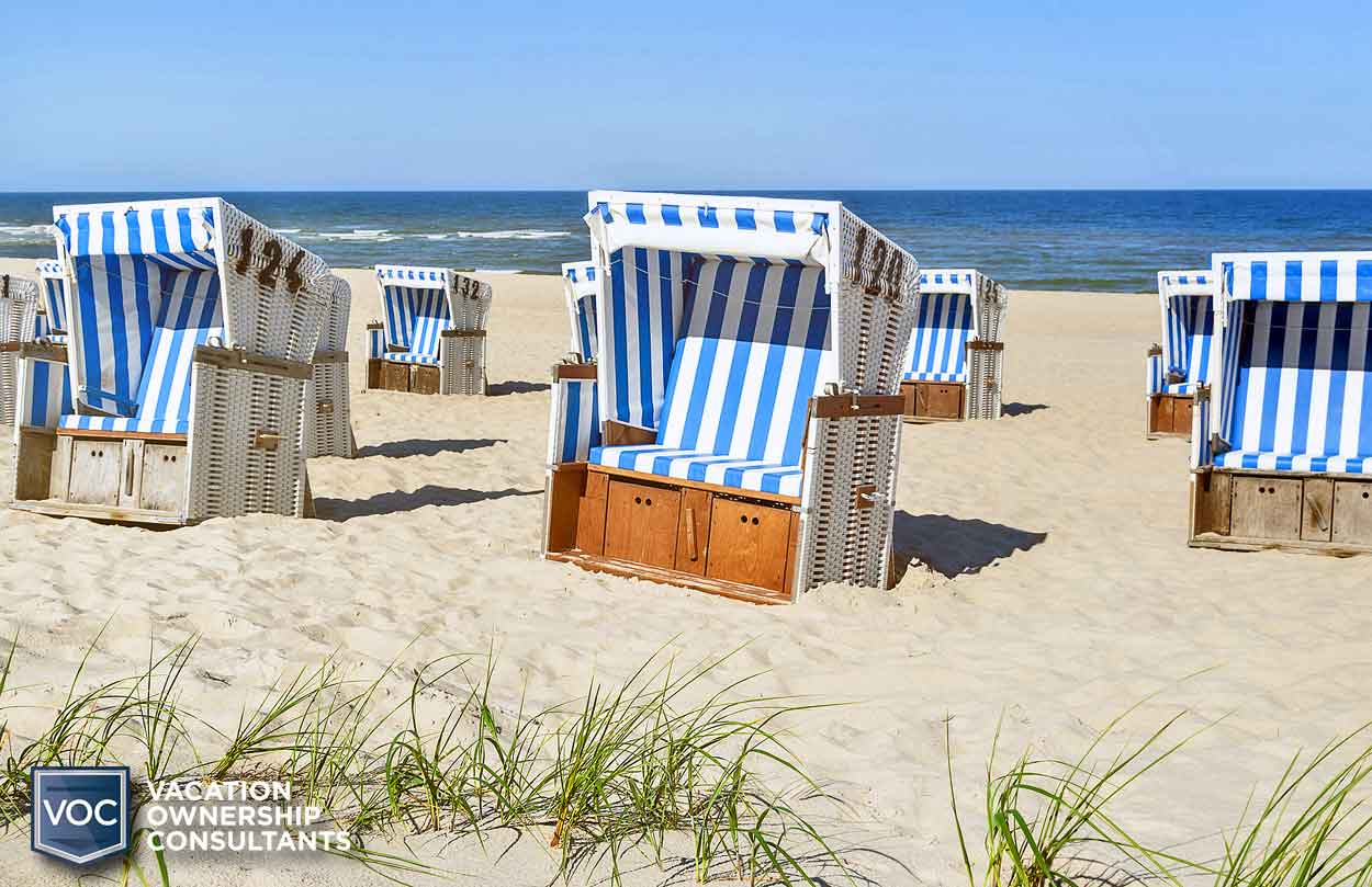 wicker-wooden-seating-on-beach-at-resort-striped-blue-linen-for-tourists-at-home-during-pandemic-of-2020