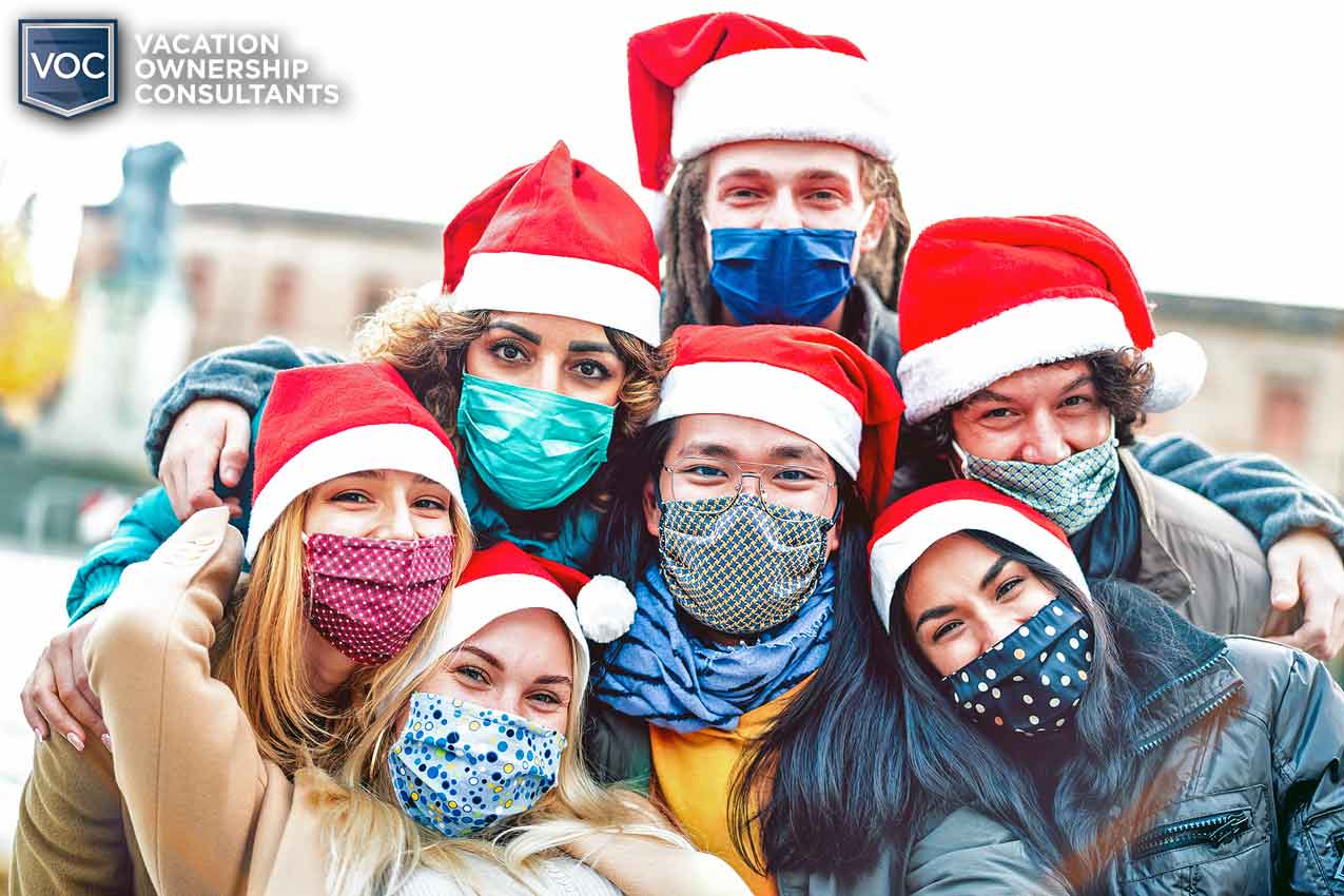 group-of-young-adults-enjoying-themselves-during-the-holidays-in-santa-clause-hats-and-covid-19-masks-for-safety-and-bacteria-in-their-lungs-from-breathing-in-dirty-breath