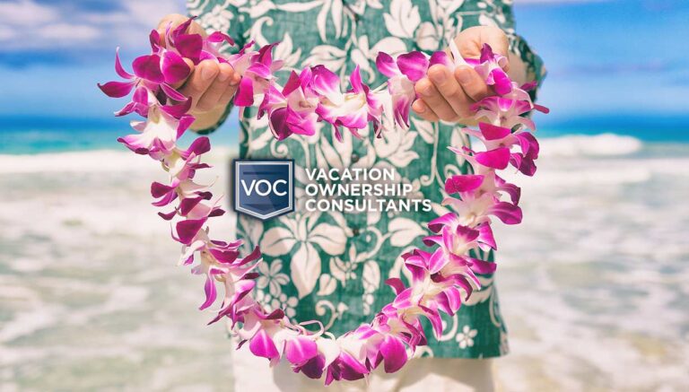 holding-flower-lei-wearing-hawaiian-culture-themed-shirt-on-beach-during-vacation-for-timeshare-news-story-during-covid-19-travel-bans