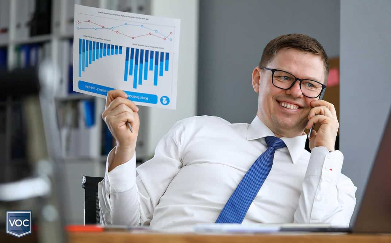 cheesy salesman on the phone holding data charts as if they carry weight when buyers exhaust your options with timeshare resorts