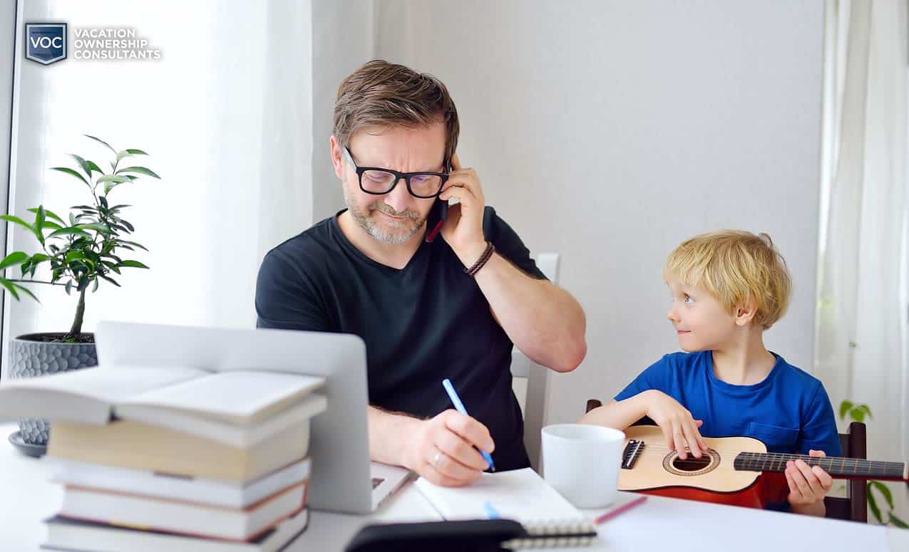 father negotiating with timeshare resort during family crisis explaining process with son while staying at home during pandemic related shutdowns 2021