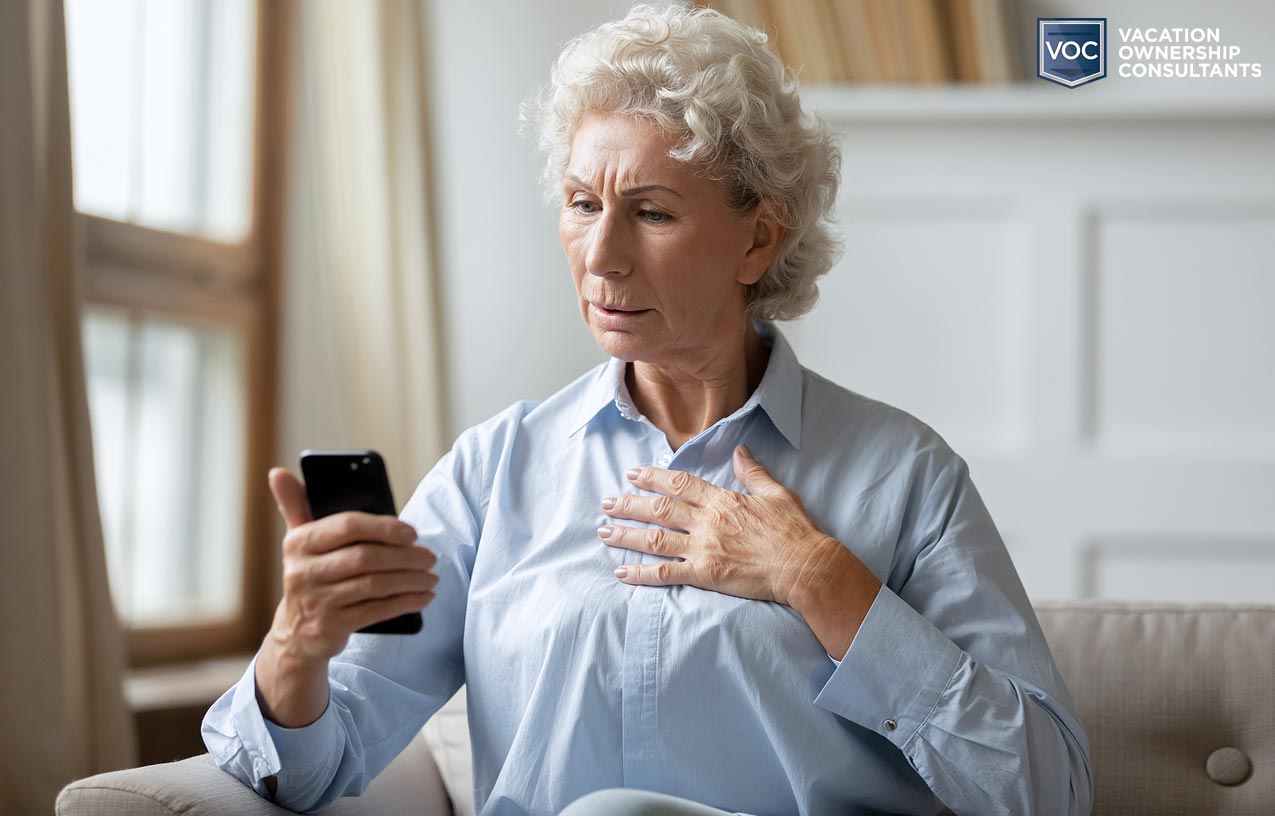 astonished grandma with tips for exiting your timeshare as she gazes at her phone with hand on heart worried about past decisions