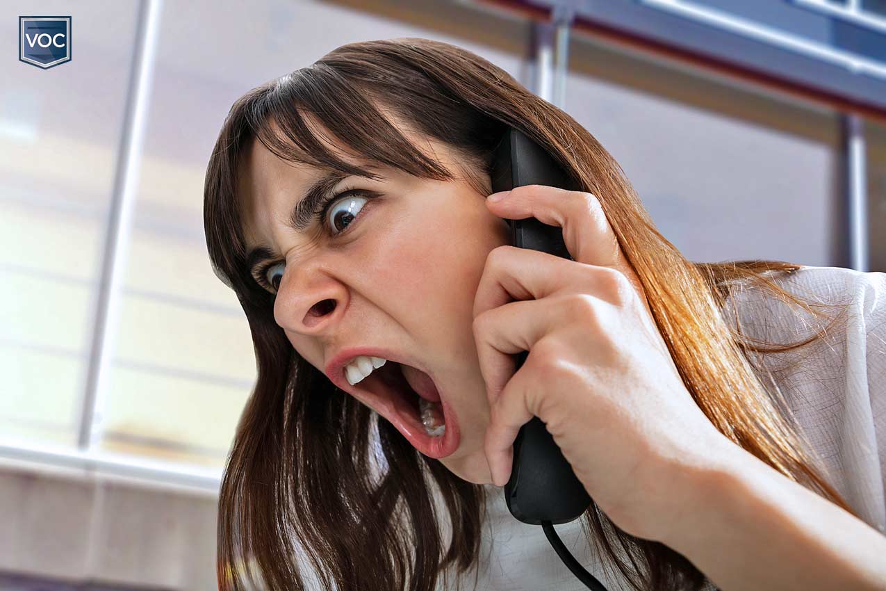 middle aged to young woman screaming into landline telephone during solicitation attempt by timeshare resort when she wants out of contractual obligations due to pandemic related issues in america